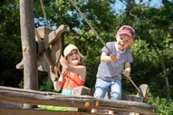 Kinder spielen auf dem großen Spielplatz der Regenesa Familienferienstätte auf Spiekeroog